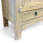 Detail of Angus Cabinet in elm showing timber grain, lower drawer and black metal ring handle