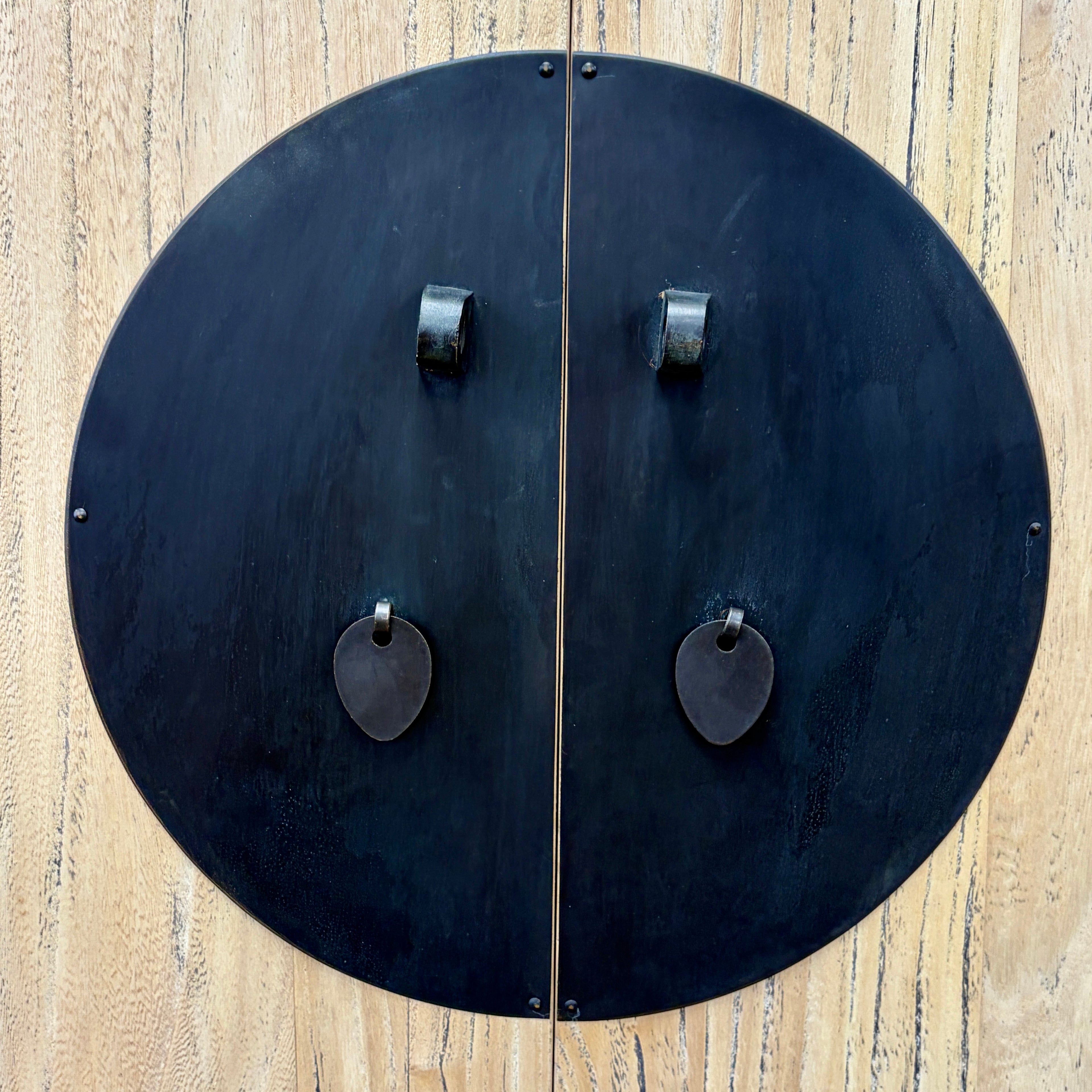 Close-up of Angus Cabinet doors showing distinctive round black metal hardware and drop handles