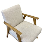 Angled view of the Ascot armchair in Oat, showcasing its clean lines and natural oak frame.
