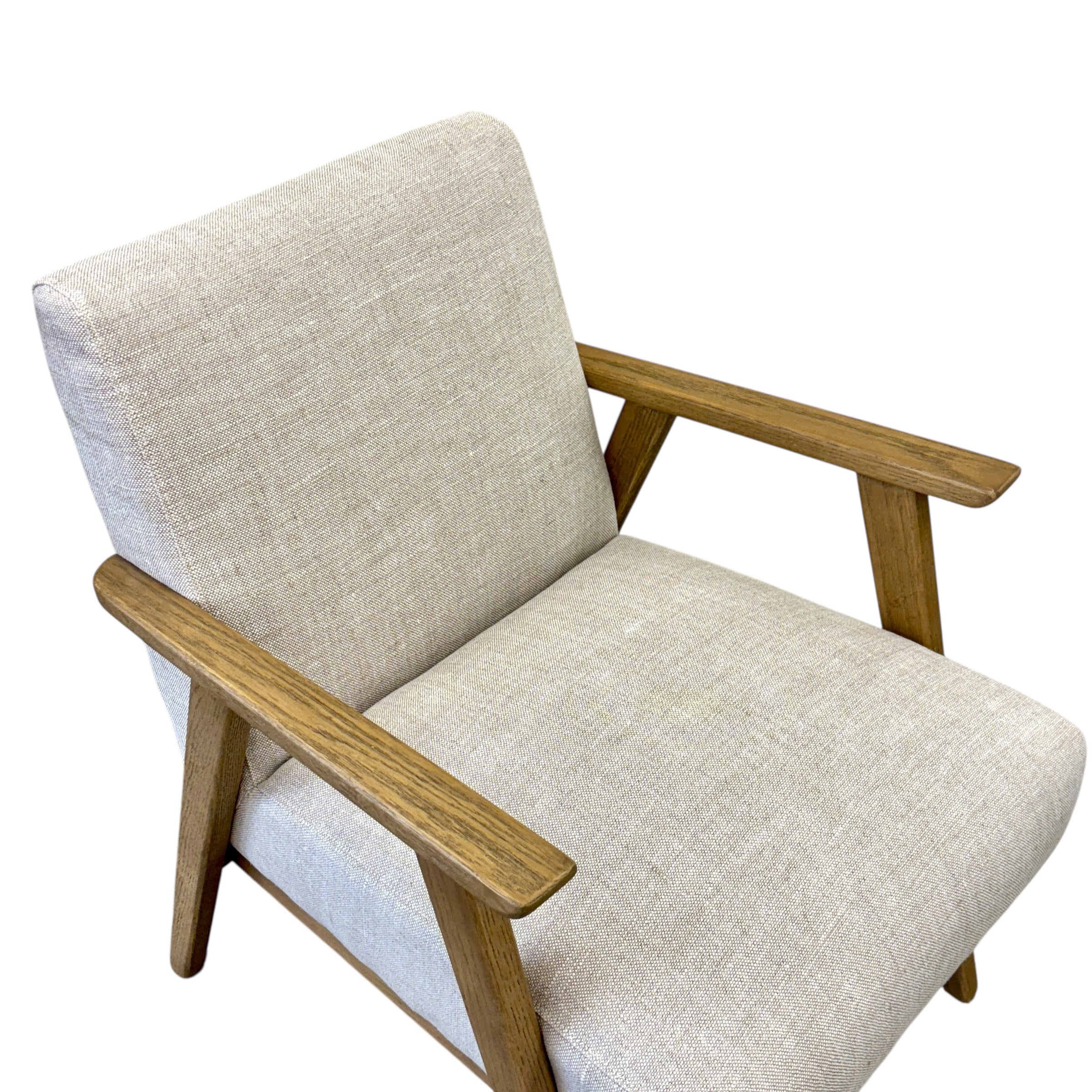 Angled view of the Ascot armchair in Oat, showcasing its clean lines and natural oak frame.