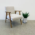 Angled view of the Ascot armchair in Oat, showcasing its clean lines and natural oak frame.