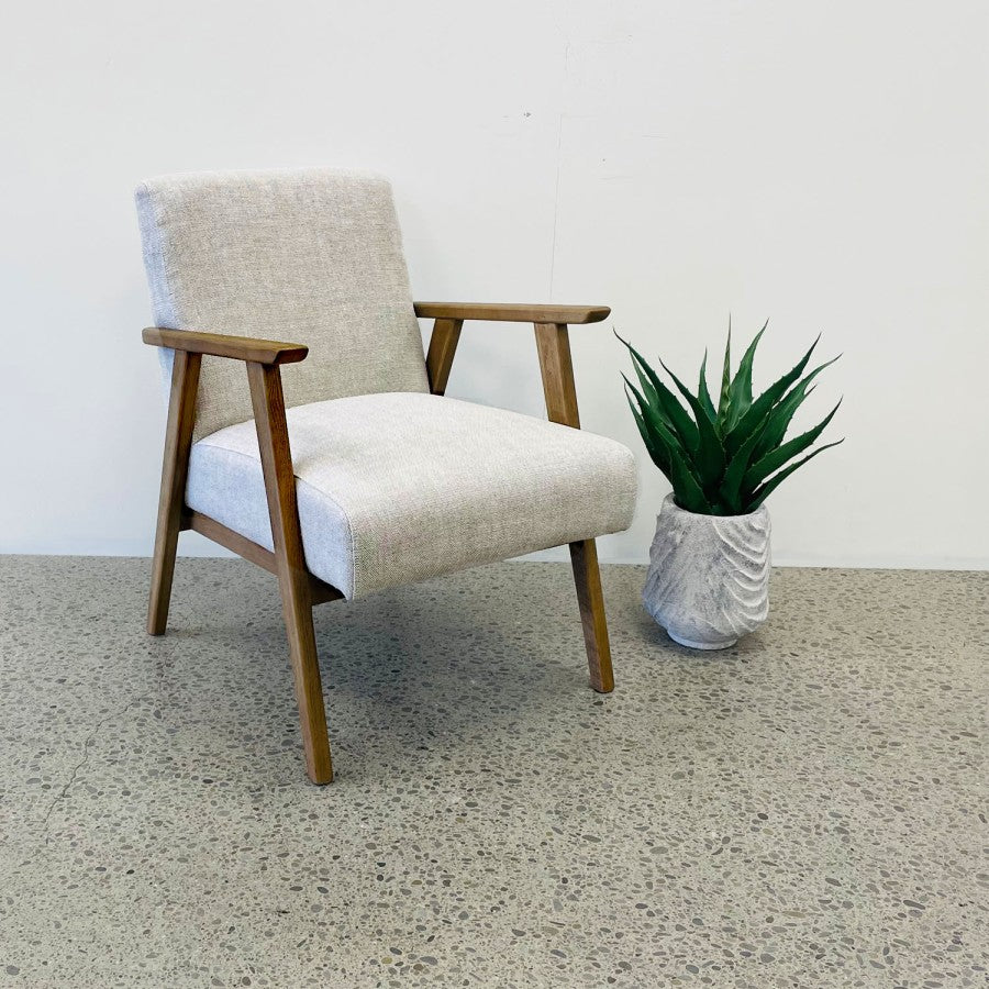 Angled view of the Ascot armchair in Oat, showcasing its clean lines and natural oak frame.