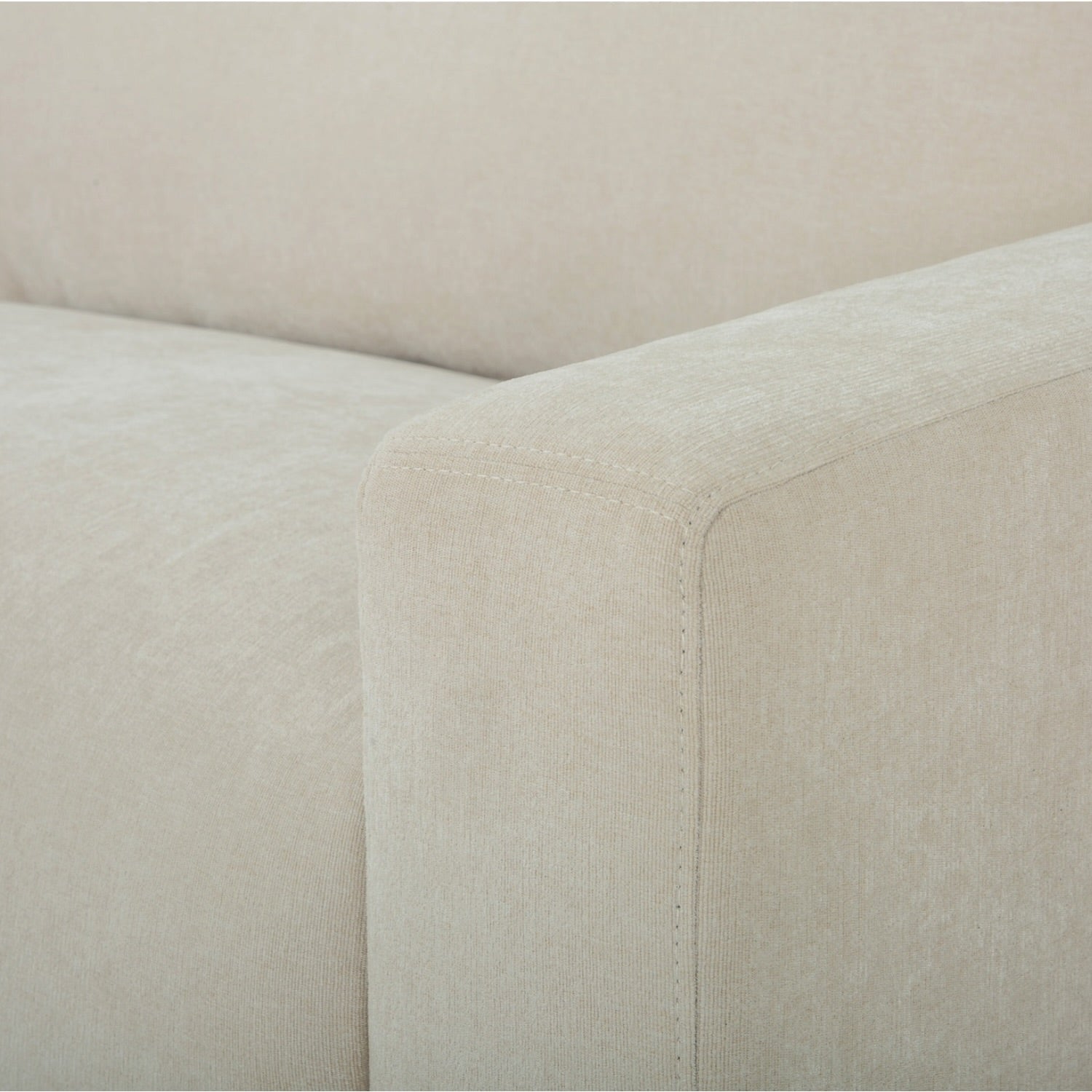 Close-up of the Asha sofa arm, highlighting the quality upholstery and tailored finish.