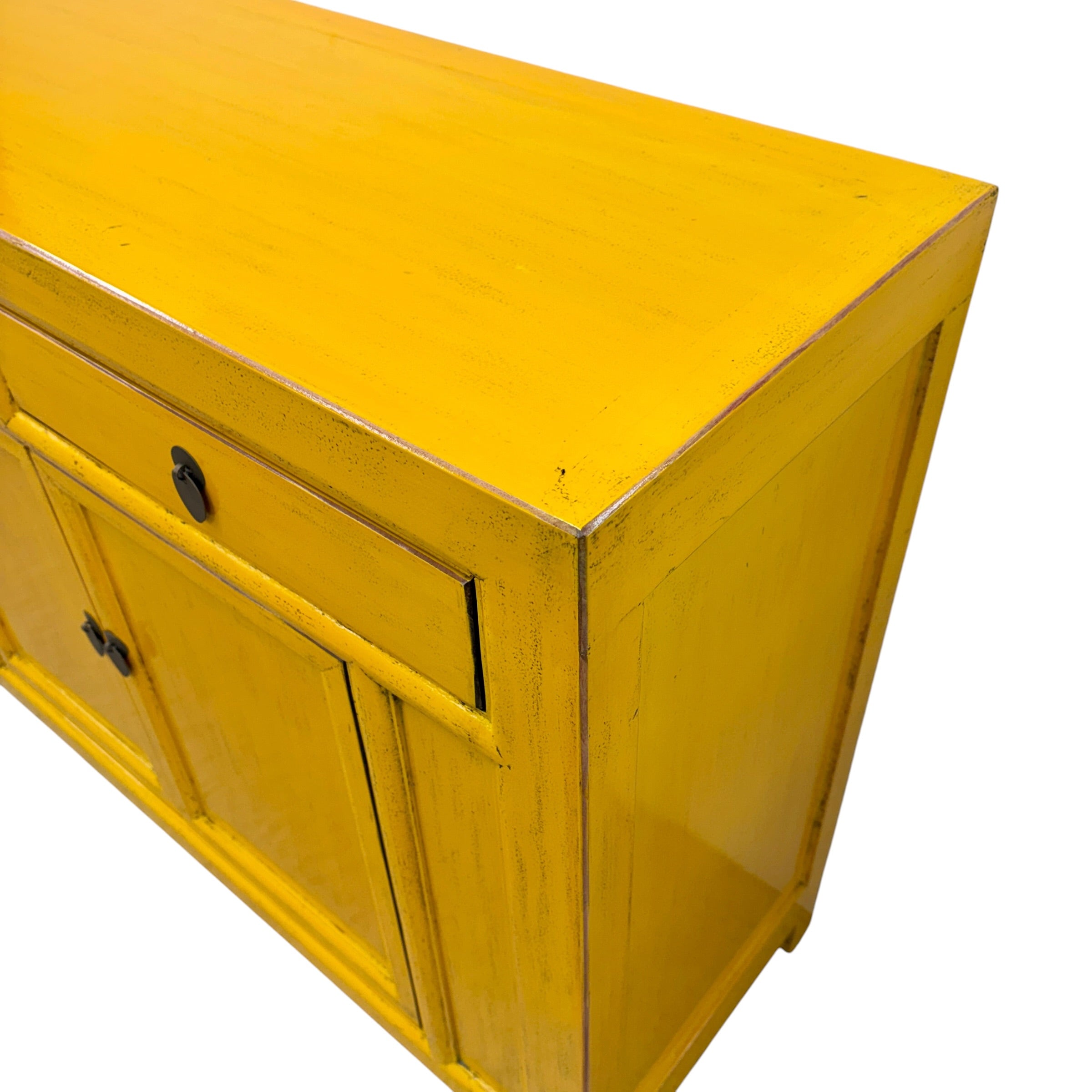 Close angled view of Elliot Sideboard in saffron showing distressed painted finish, timber top and dark metal handles