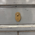 Close-up of distressed glossy grey lacquer finish and brass handle on Far East bedside cabinet