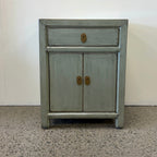 Far East Bedside in sage grey with distressed lacquer finish, drawer, two doors and brass handles