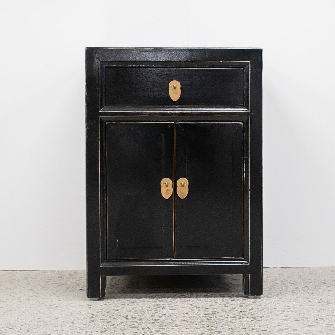 Far East solid timber bedside cabinet in distressed black lacquer with drawer, two doors and brass handles