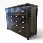 Angled view of Franklin 18 Drawer Cabinet in black with 18 drawers, panelled sides and brass-toned handles