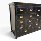 Side angled view of Franklin 18 Drawer Cabinet showing black finish, panelled side and brass-toned drawer handles