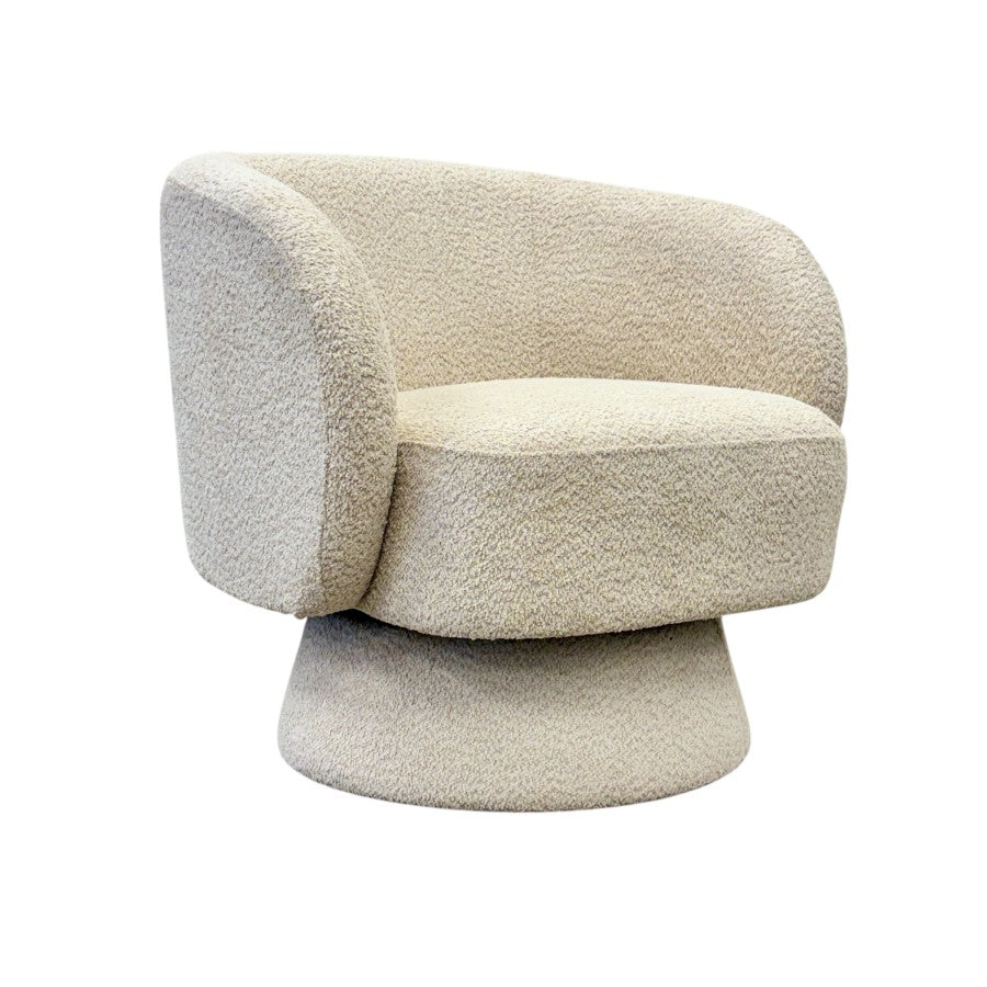 Side profile of the Jenna swivel armchair in Pebble with a concealed swivel base.