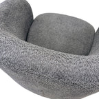 Close-up of the Jenna swivel armchair in Shadow, featuring soft textured upholstery and contemporary styling.