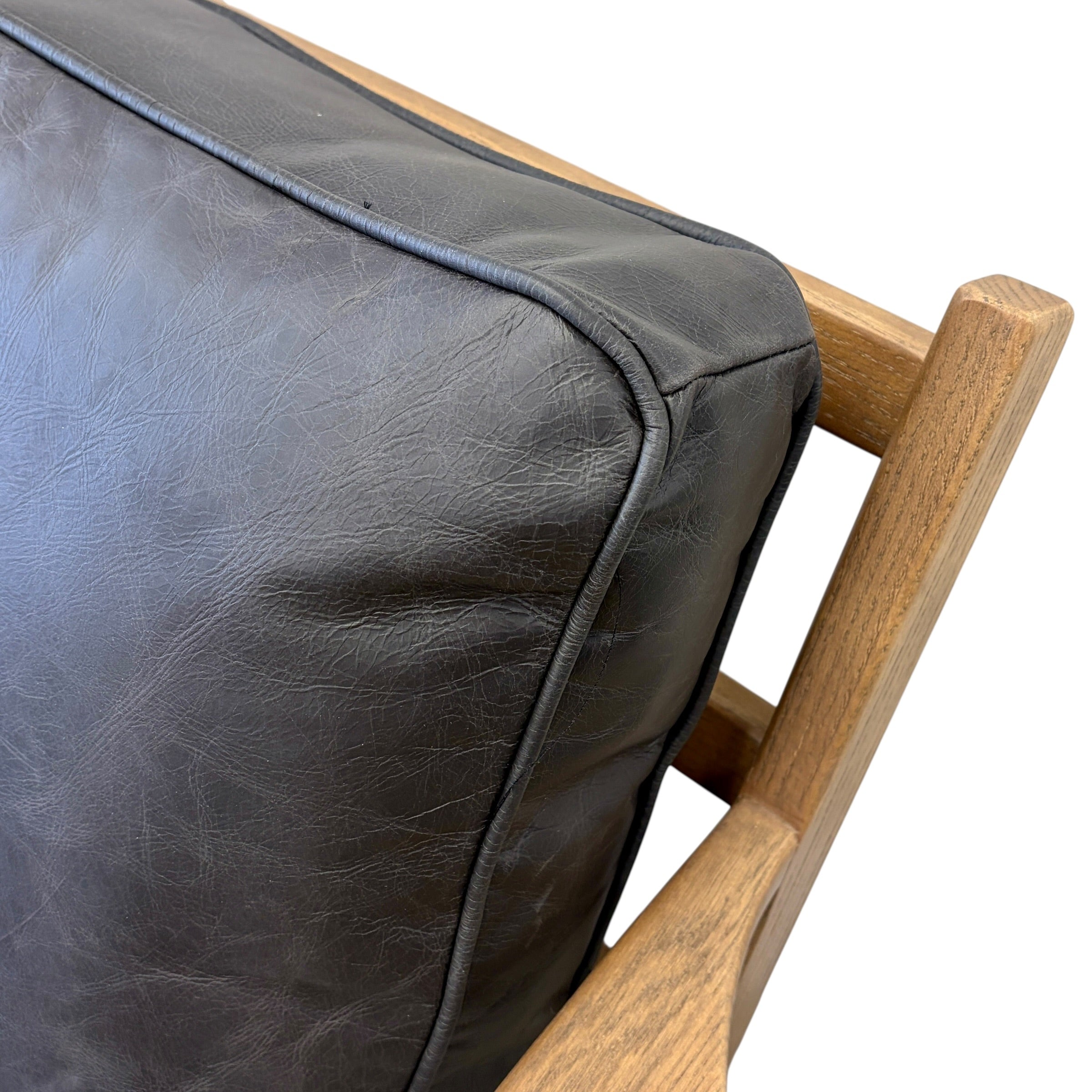 Close-up of the Nero armchair's premium leather upholstery, showcasing the natural texture and quality finish.