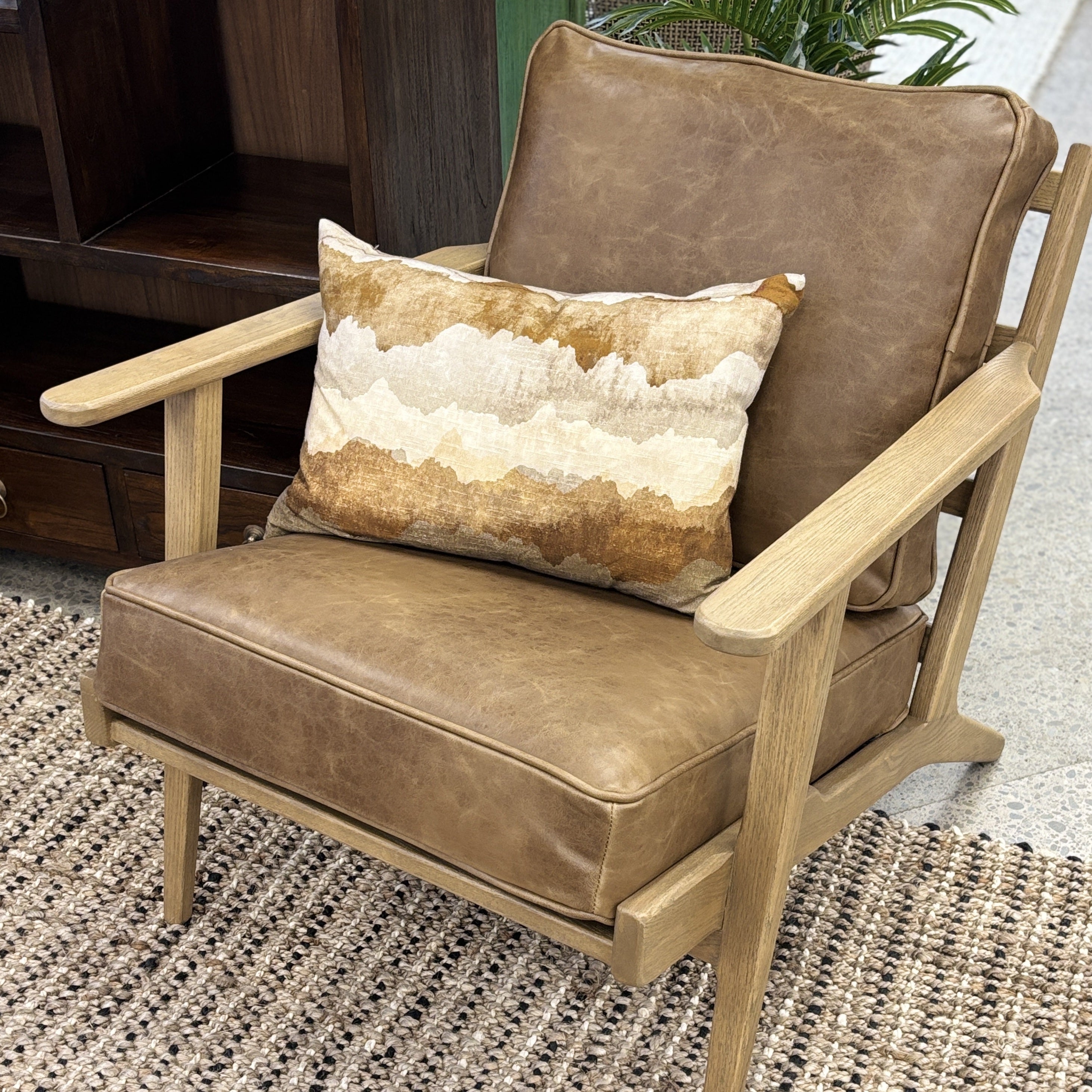 Nero armchair styled in a contemporary living room with complementary furniture and décor.