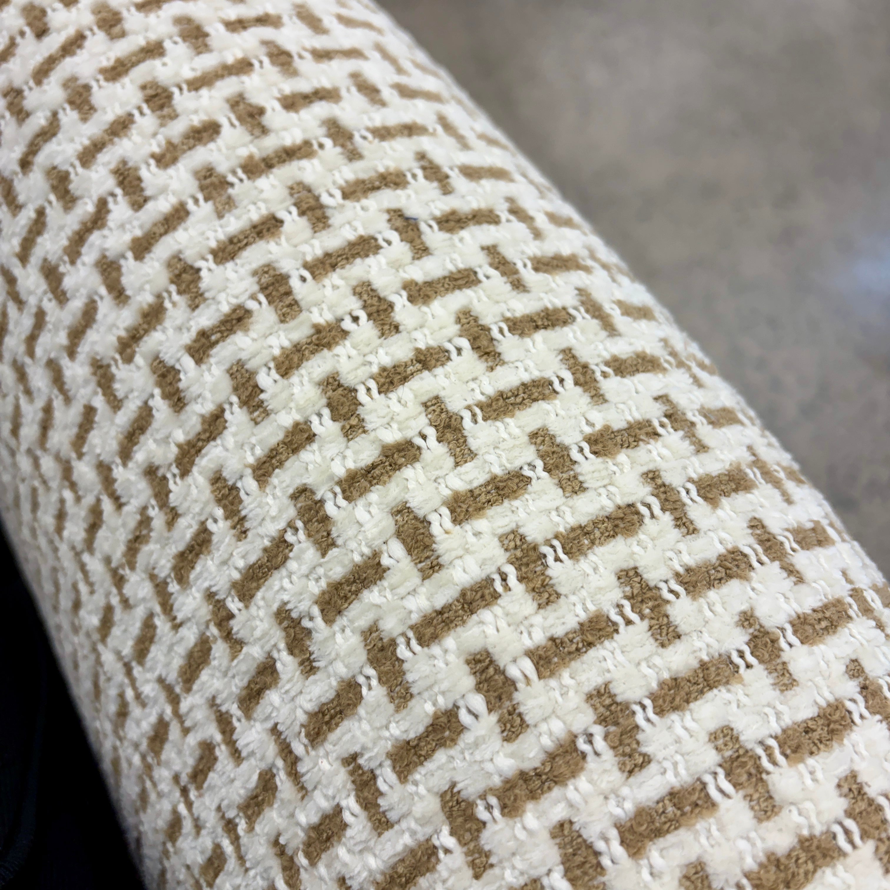 Close-up of the Piper armchair's textured woven fabric upholstery.