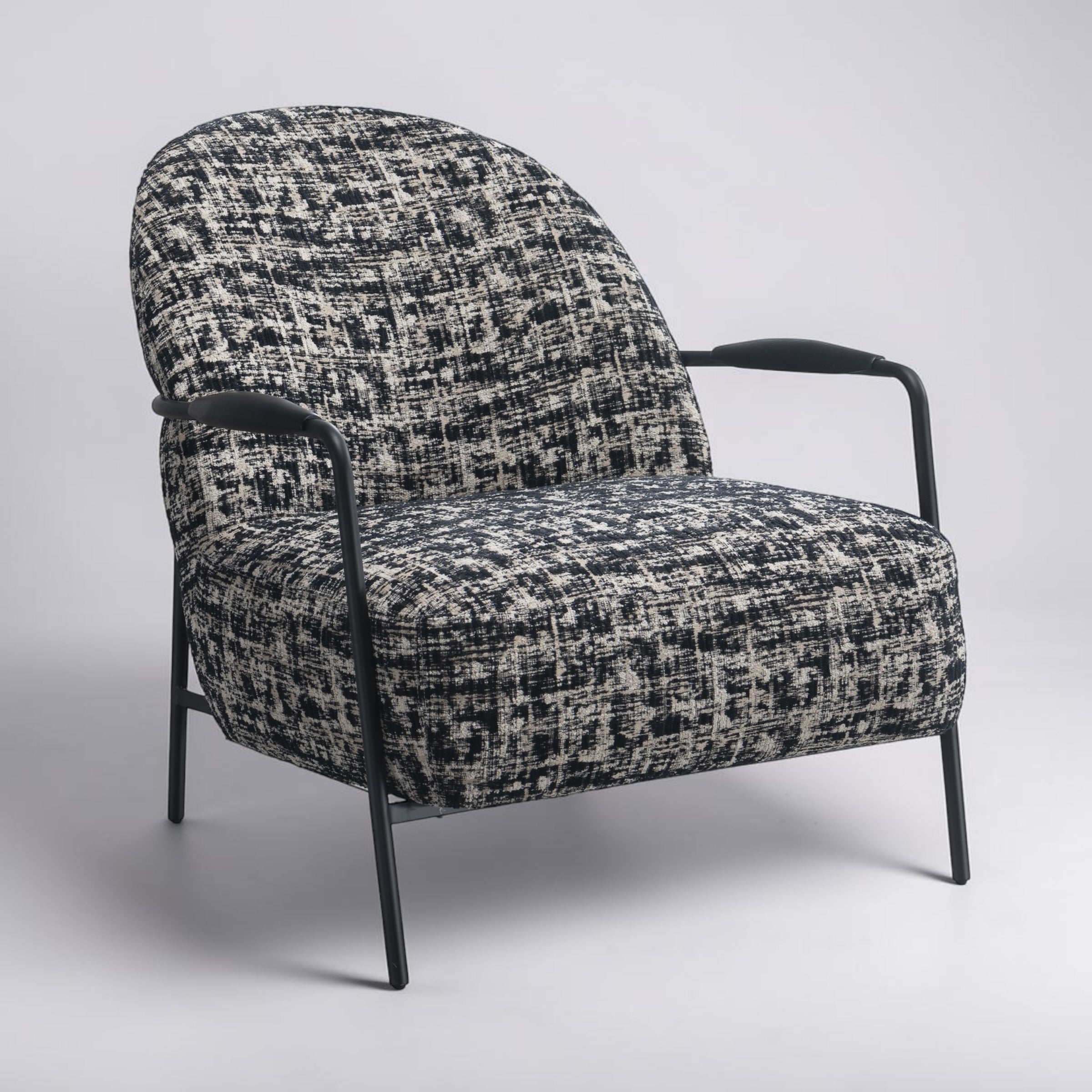 Side profile of the Portia armchair with a curved back and generously cushioned seat.