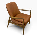 Angled view of Portobello Chair in toffee leather with sculpted solid oak arms and timber frame