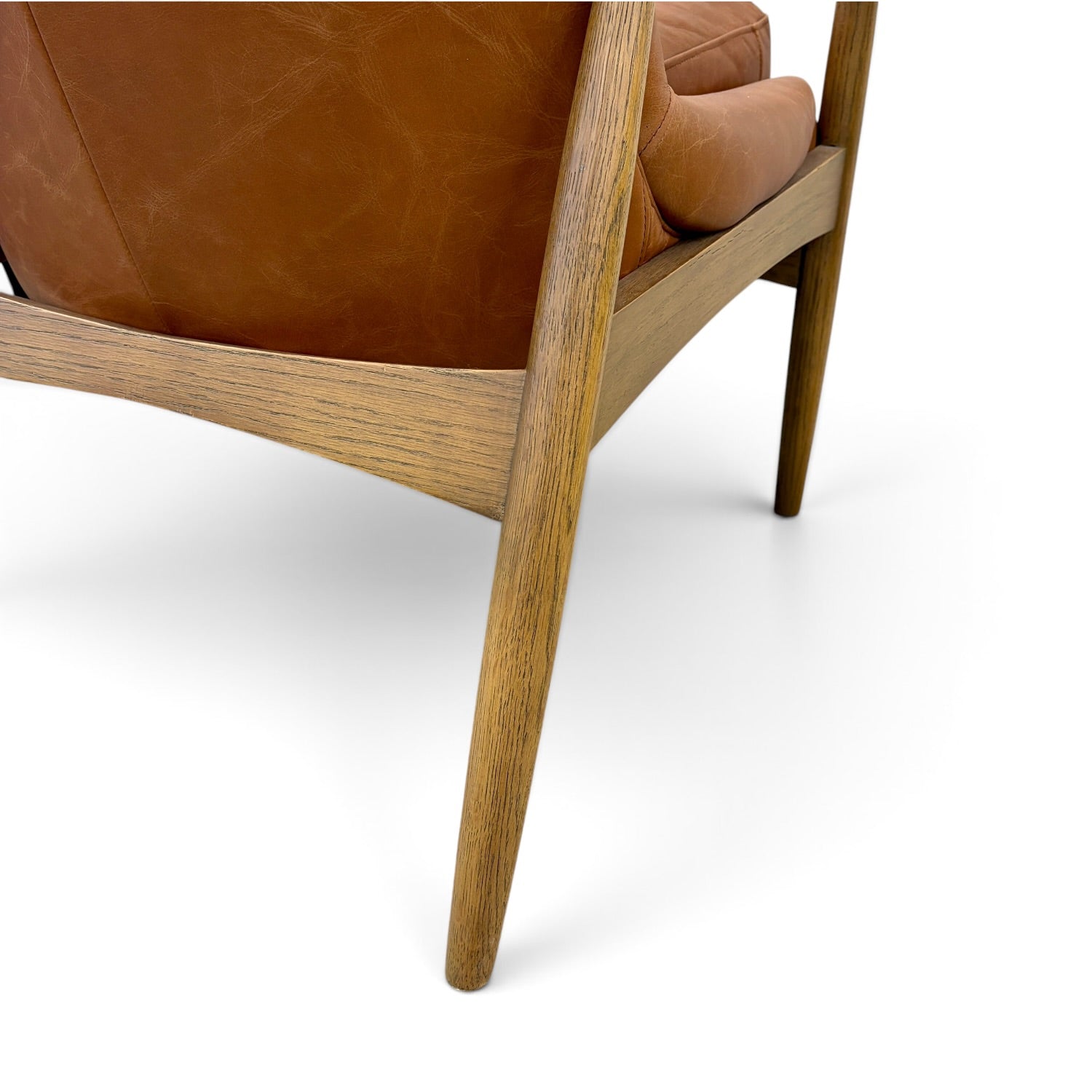 Close-up of Portobello Chair in toffee leather showing the solid oak frame and leather upholstery