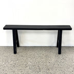 Black rustic elm Sammy Bench with long narrow seat and traditional trestle-style base
