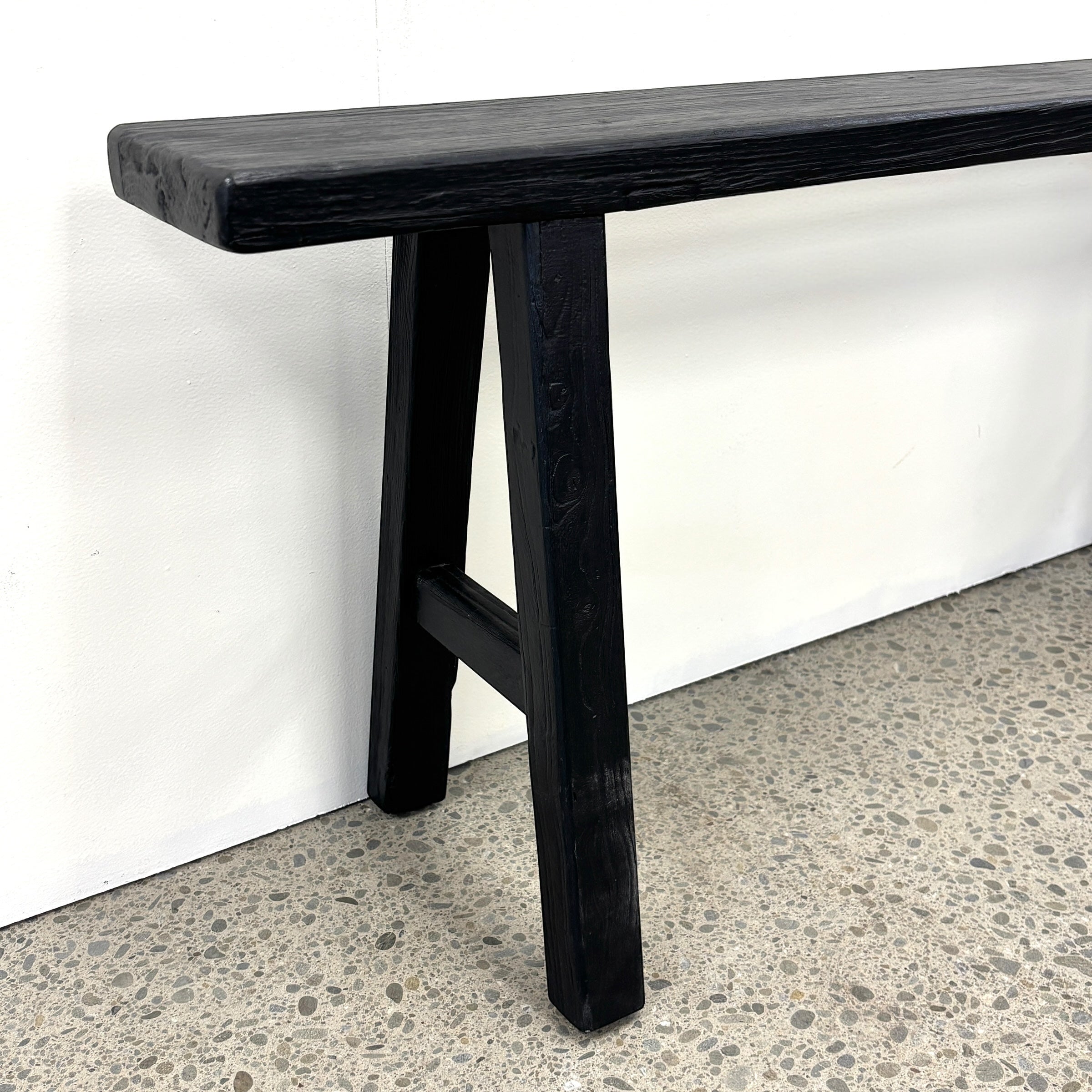 Sammy Bench black rustic elm leg detail showing traditional trestle-style construction