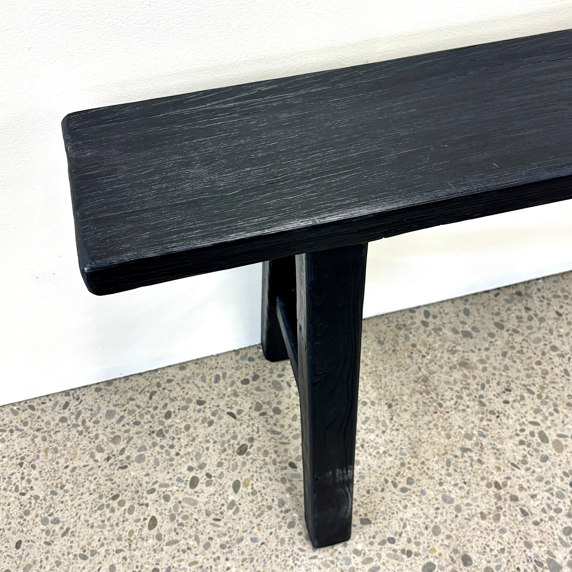 Close-up of Sammy Bench showing black painted finish and natural rustic elm wood grain