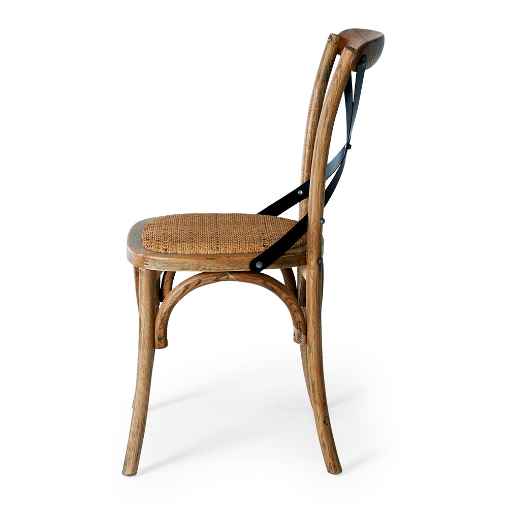 Villa dining chair in smoked oak with a woven seat and metal cross back from side view