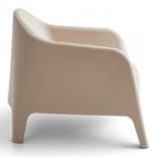 Side view of the Wainui outdoor chair in sand with a smooth curved silhouette