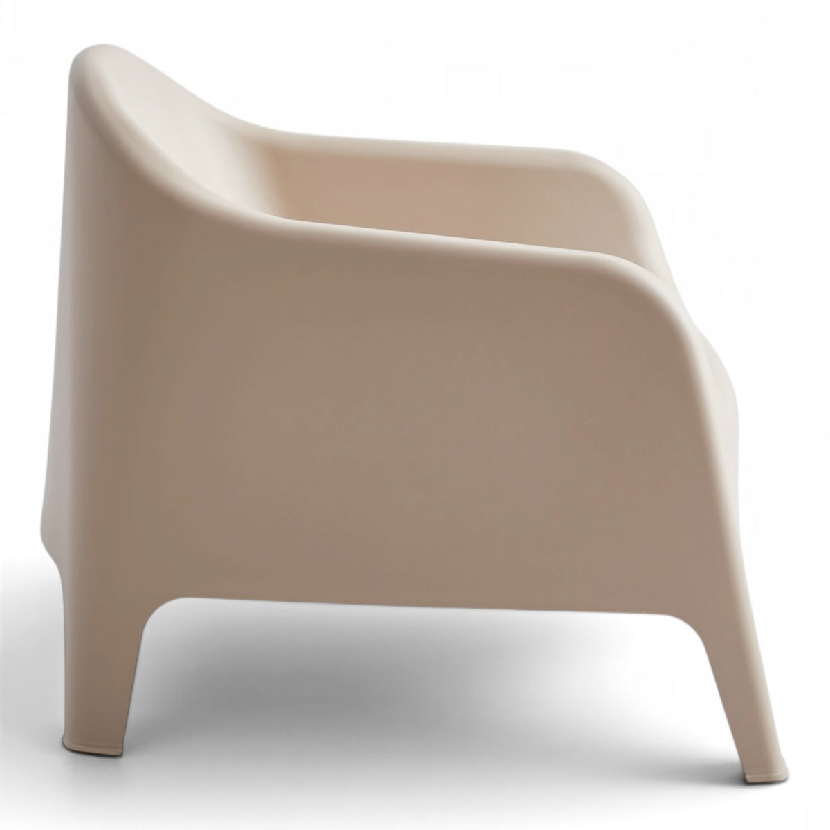 Side view of the Wainui outdoor chair in sand with a smooth curved silhouette