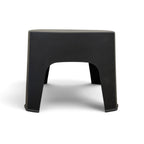 Side view of Wainui black outdoor side table showing its compact curved design
