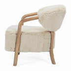 Side profile of the Yak Armchair in Natural showing curved ash timber arms and plush faux fur upholstery.