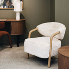 Yak Armchair in Natural faux fur upholstery styled in a contemporary living room with solid ash timber frame.