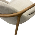 Close-up of the Adeline armchair's natural ash frame, showcasing the curved timber design and quality craftsmanship.