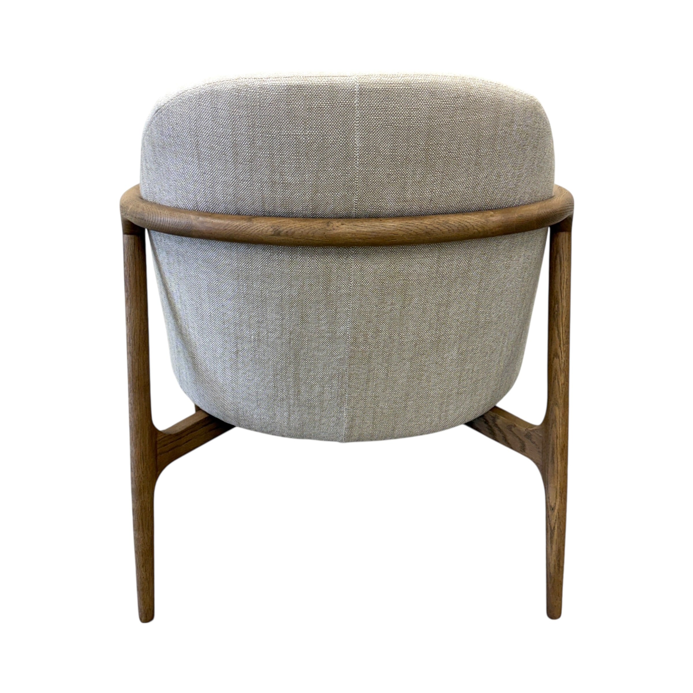 Close-up of the Adeline armchair's natural ash frame, showcasing the curved timber design and quality craftsmanship.