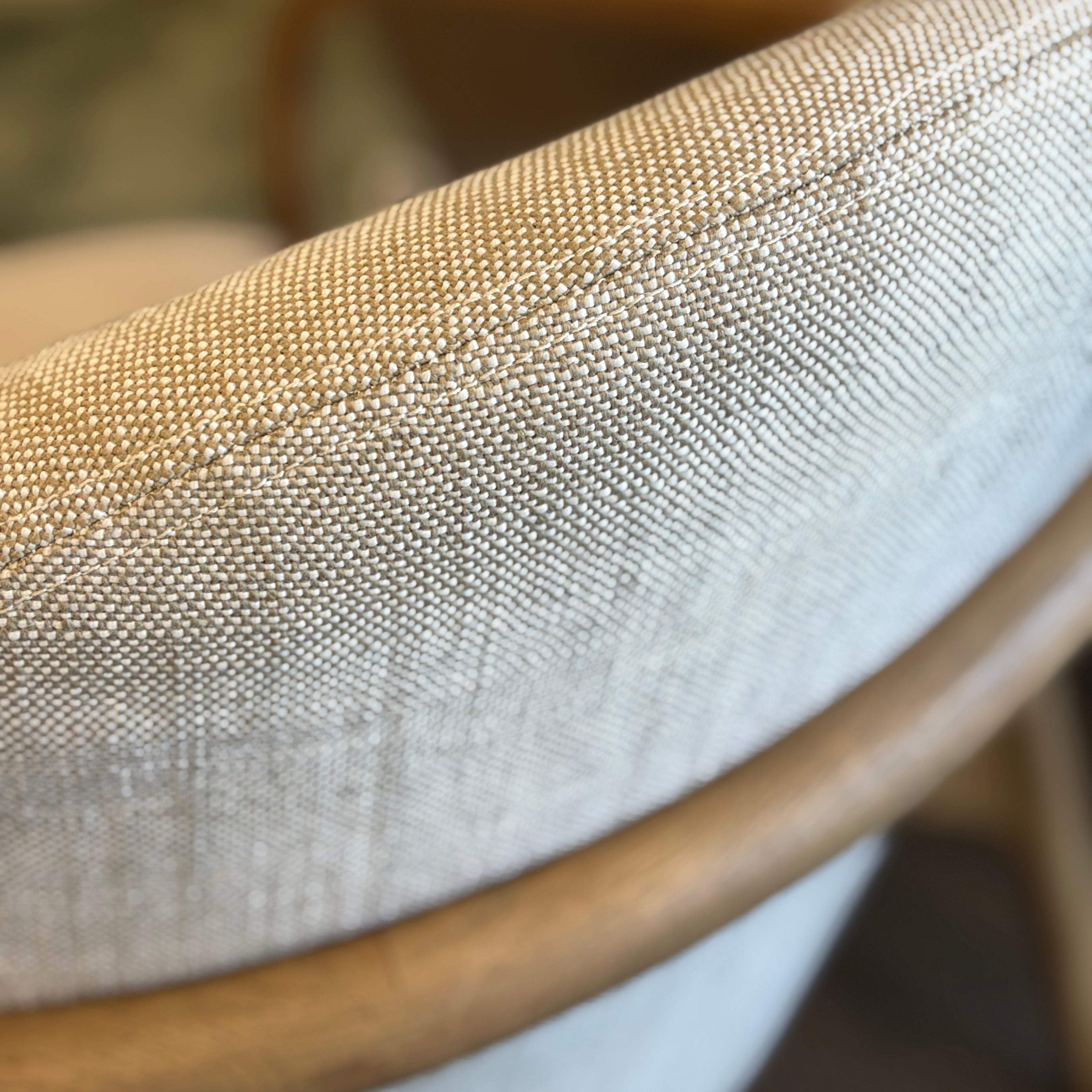 Close-up of the Adeline armchair's 100% natural linen upholstery, highlighting the soft woven texture.