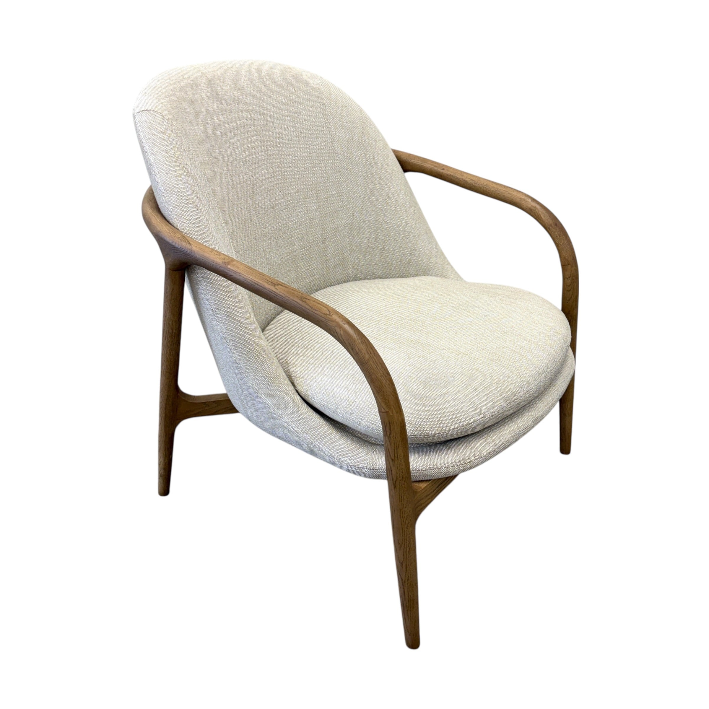 Side profile of the Adeline fabric armchair with a curved natural ash frame and linen upholstered seat.