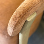 Close-up of the Aiden Chair's Burnt Orange woven fabric upholstery, highlighting its soft texture and quality finish.