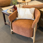 Aiden Chair in Burnt Orange styled in a contemporary living room with natural timber furniture.
