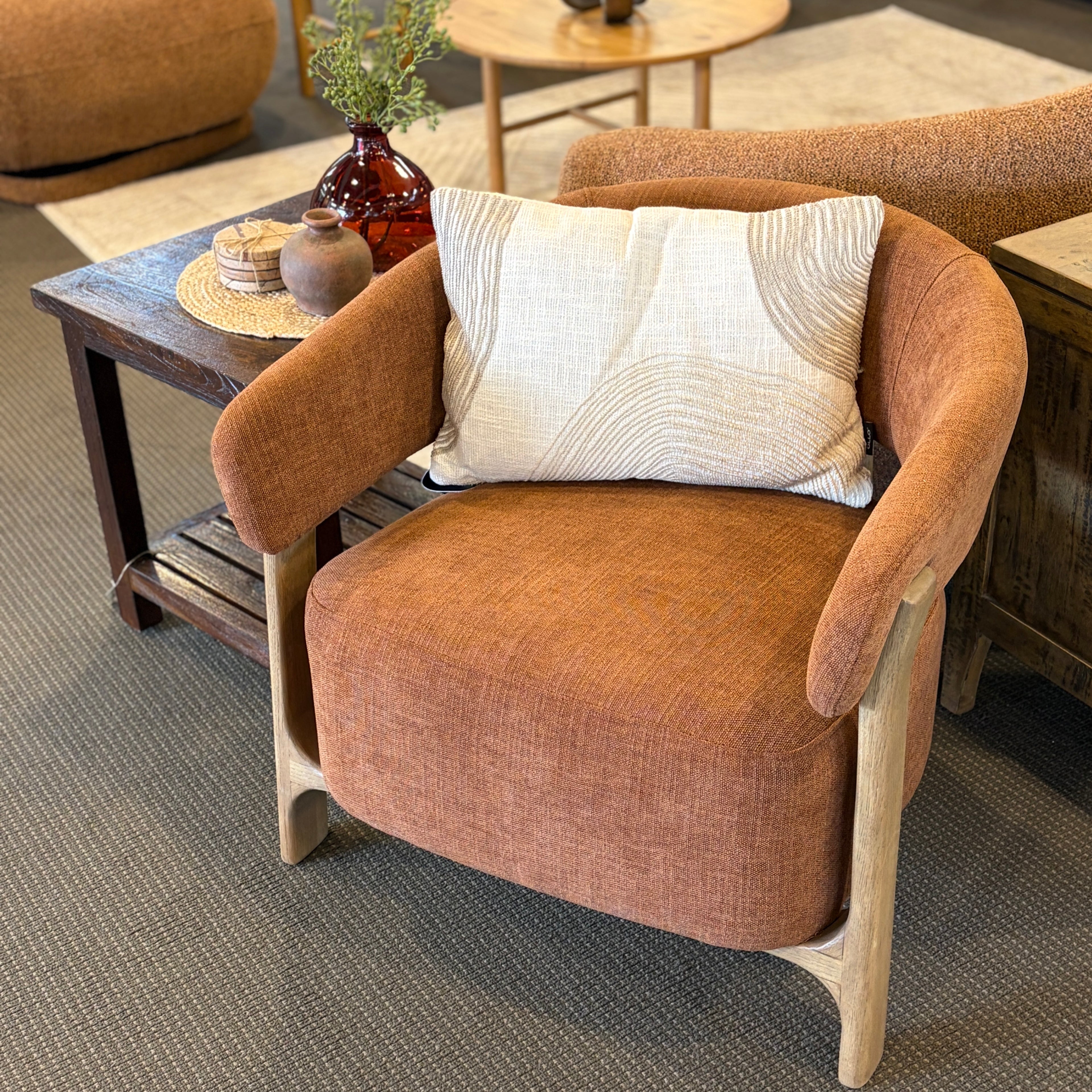 Aiden Chair in Burnt Orange styled in a contemporary living room with natural timber furniture.