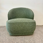 Angled view of the Arlo Chair in Fern with feather-filled cushions, soft upholstery and a beautifully crafted oak frame.