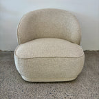 Angled view of the Arlo Chair in Grain with rounded contours, textured upholstery and contemporary styling.