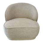 Arlo Chair in Grain with a sculptural curved design, generously cushioned seat and soft textured upholstery.