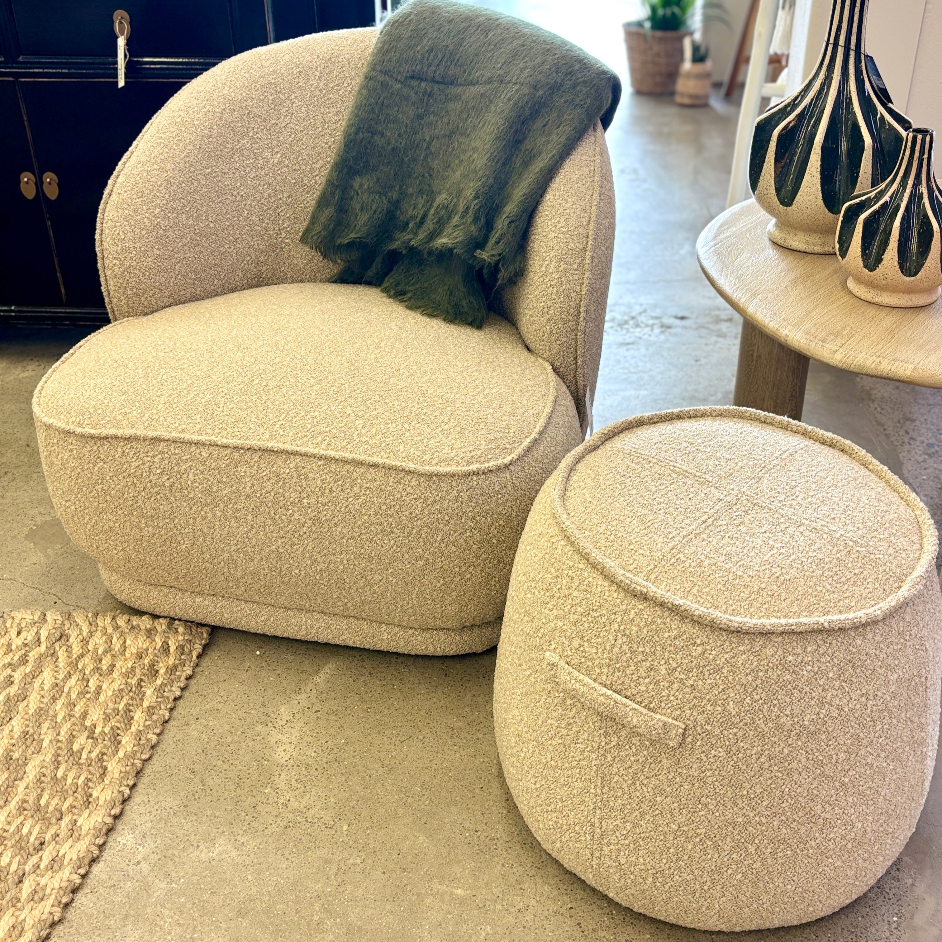 Arlo Chair in Grain styled in a contemporary living room, showcasing its soft neutral upholstery and sculptural silhouette.