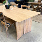 Ava Dining Table in Natural displayed in the Java Furniture showroom, showcasing its solid mango wood construction and contemporary styling.