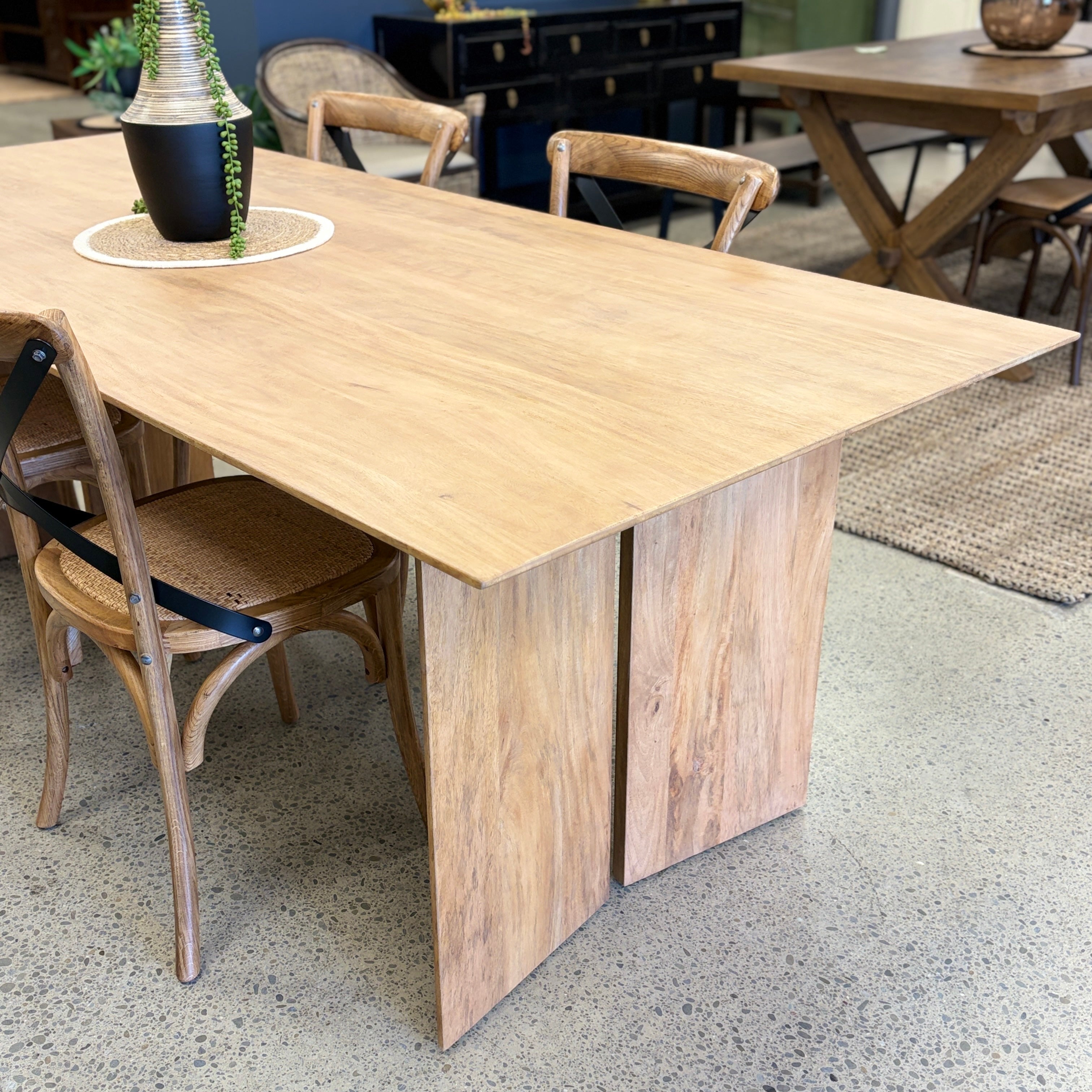 Ava Dining Table in Natural displayed in the Java Furniture showroom, showcasing its solid mango wood construction and contemporary styling.