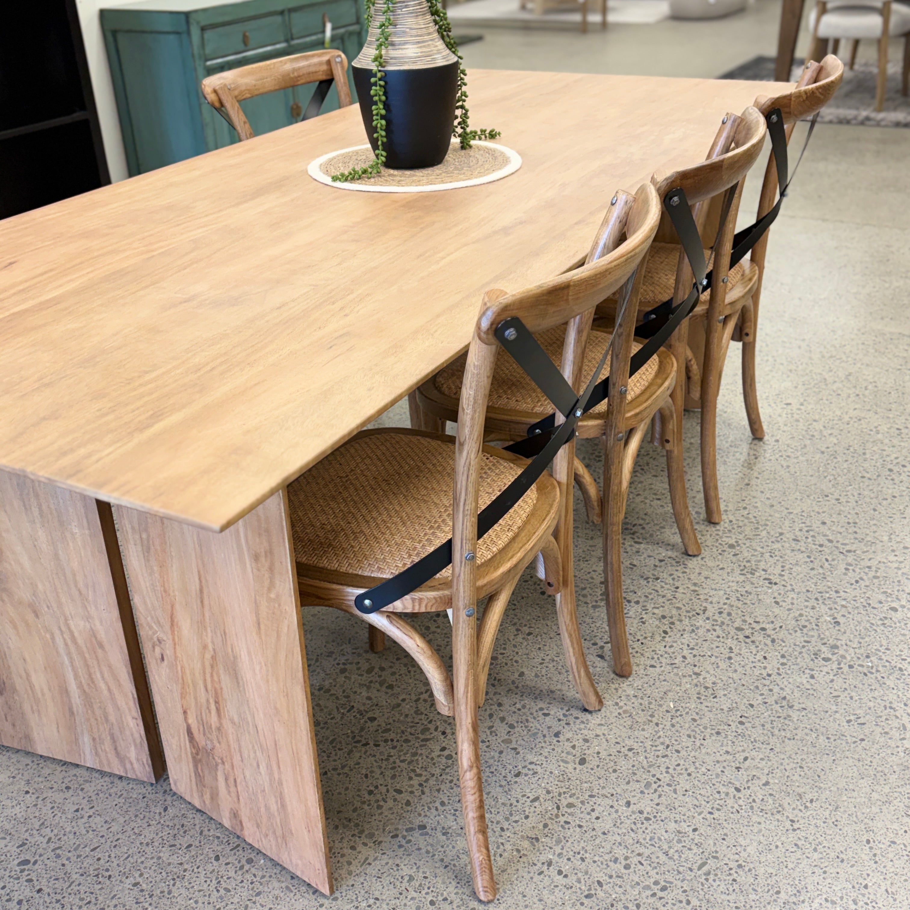 Ava Dining Table in Natural styled with dining chairs, showcasing its contemporary design and spacious 6-seater proportions.