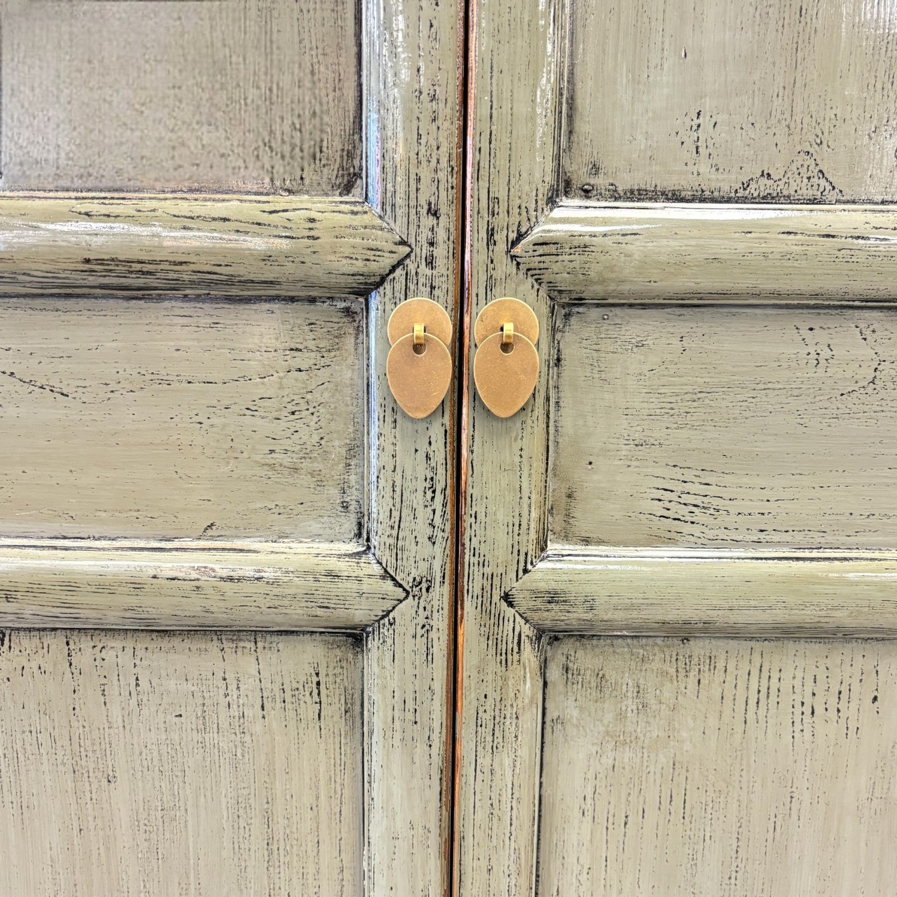 Close up of Ayla Storage Cupboard Smoke showing textured olive grey finish and gold toned handles