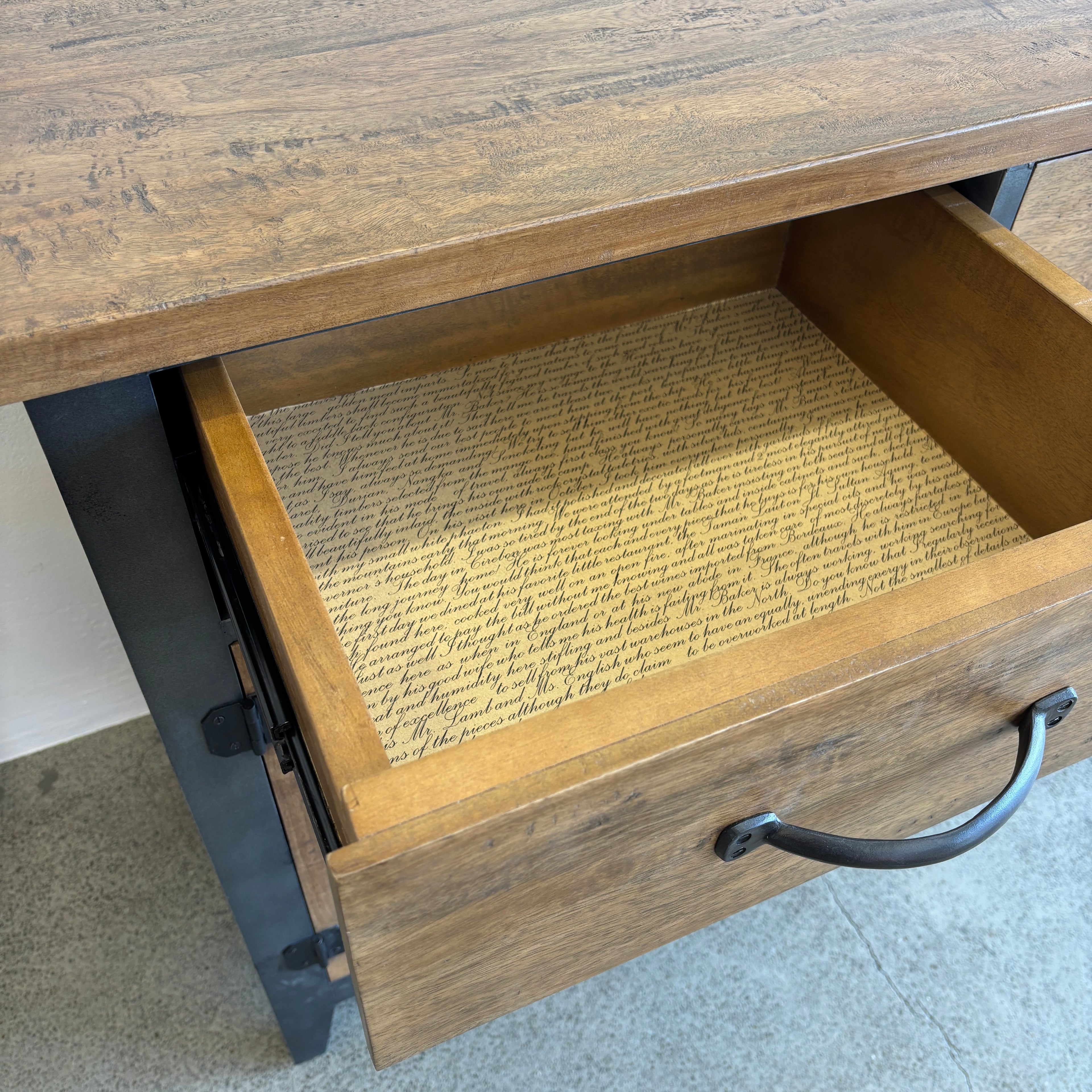 Open drawer on the Barber 3 Door Sideboard showing mango wood construction and dark metal handle