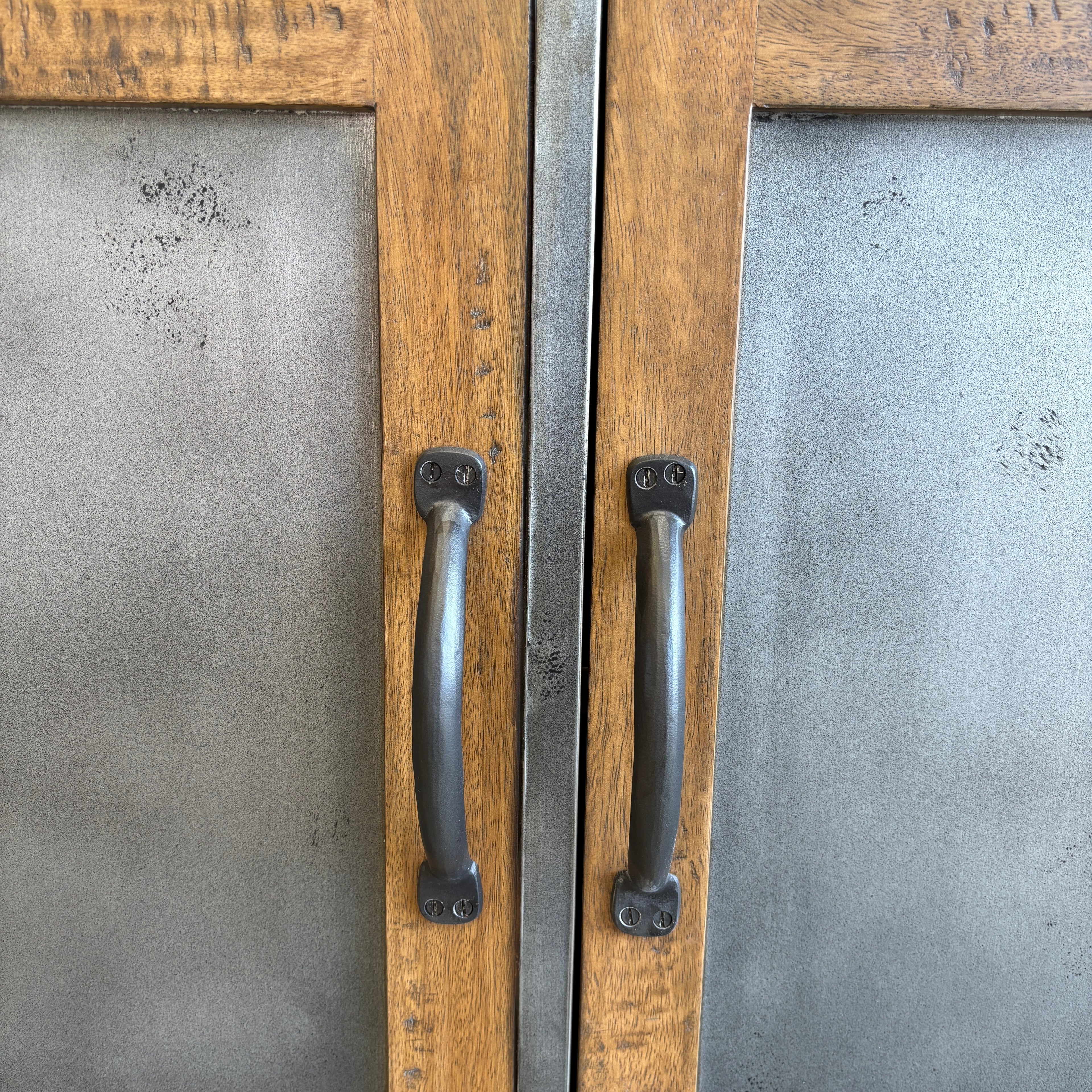 Close-up of brushed steel doors and dark metal handles on the Barber 3 Door Sideboard