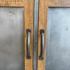 Close-up of brushed steel doors and dark metal handles on the Barber 2 Door Sideboard