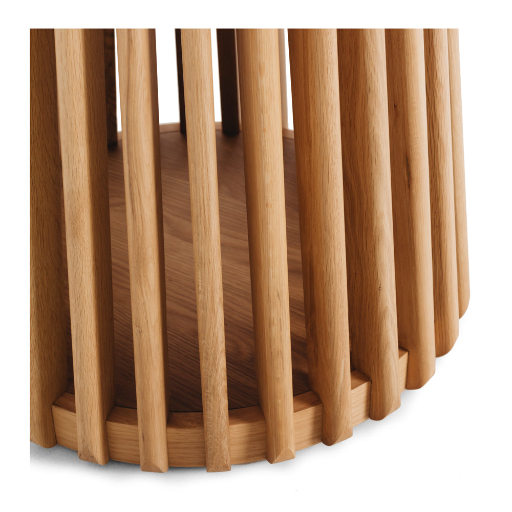 Close-up of the Bur Round Dining Table's distinctive slatted oak pedestal base, creating a sculptural focal point while providing generous legroom.