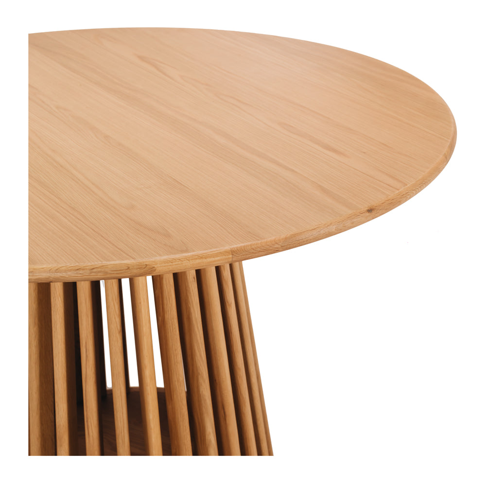 Close-up of the Bur Round Dining Table's oak tabletop, showcasing the natural timber grain and smooth protective finish